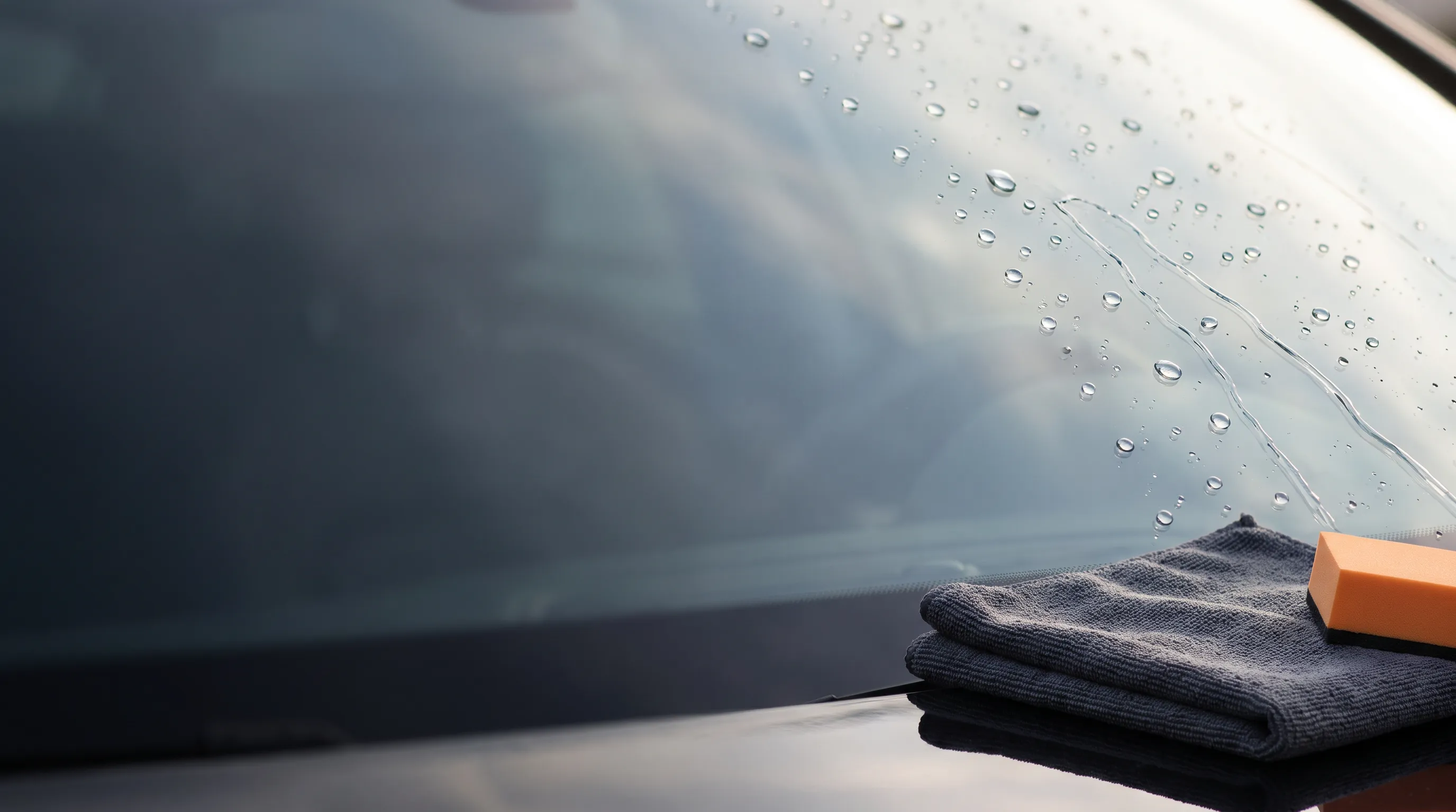 Illustration of hydrophobic water beading on treated windshield glass