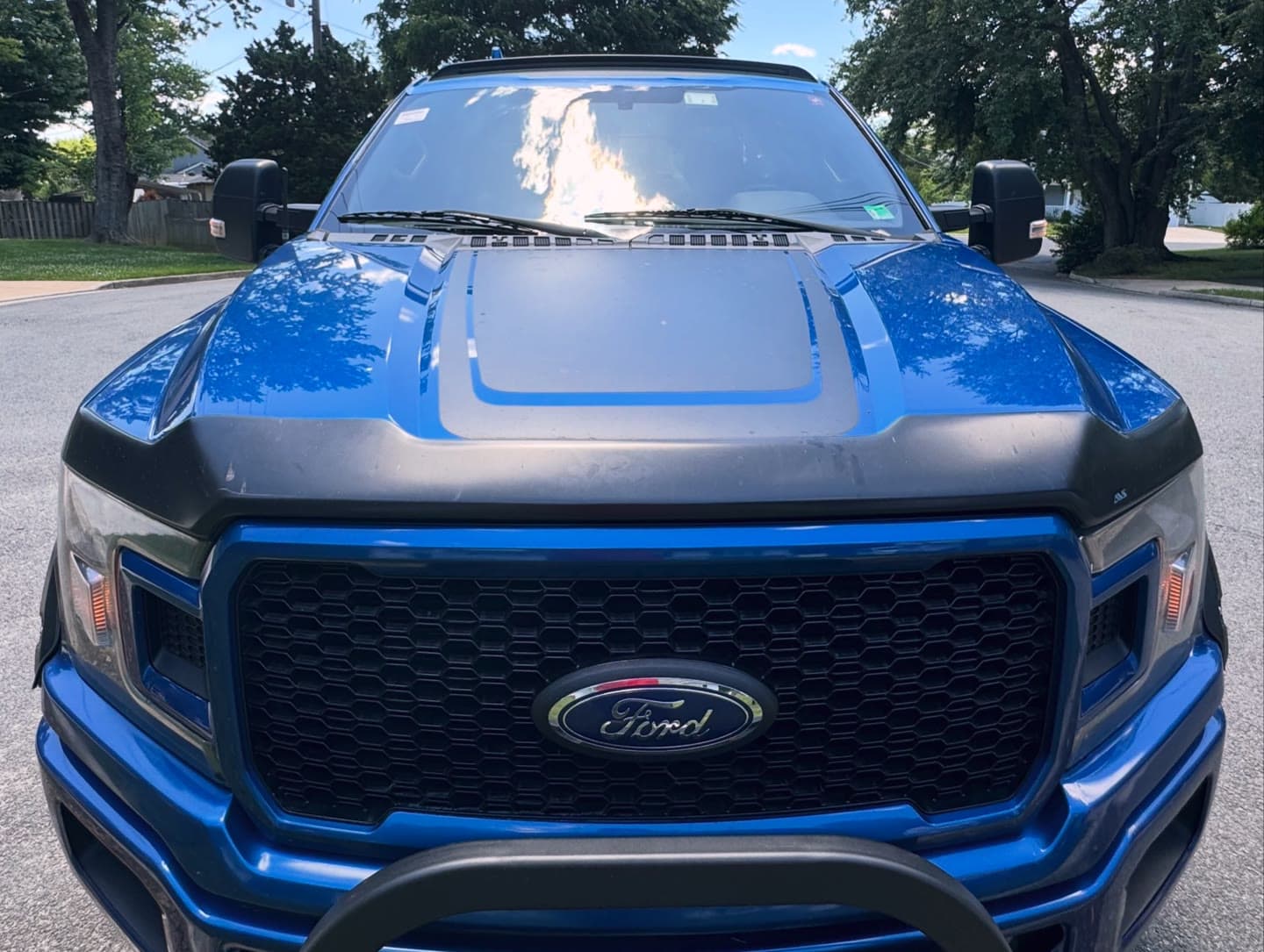 Windshield replacement on a blue Ford F-150, old glass removed and new windshield installed