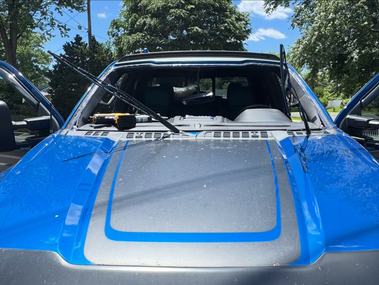 Windshield replacement on a blue Ford F-150, old glass removed and new windshield installed