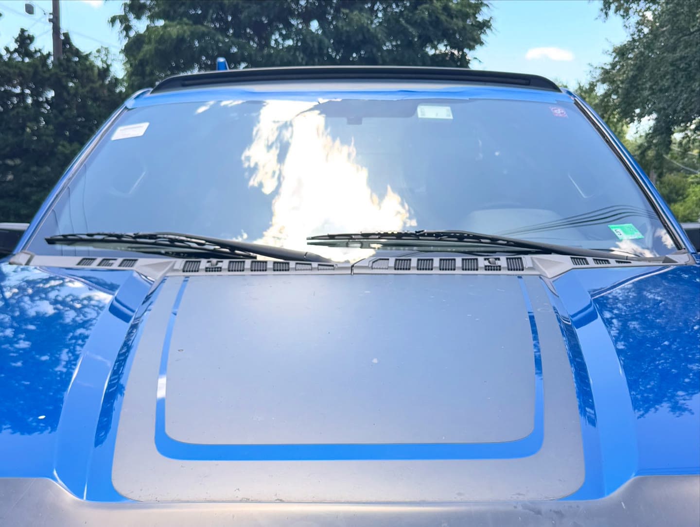 Windshield replacement on a blue Ford F-150, old glass removed and new windshield installed