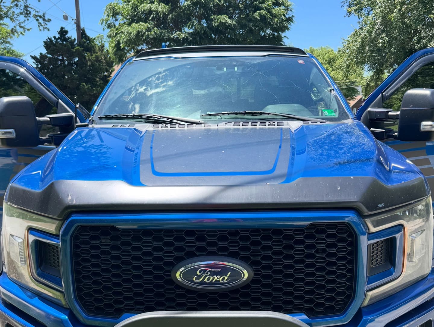 Windshield replacement on a blue Ford F-150, old glass removed and new windshield installed